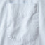 The front pocket of the light blue pinpoint oxford dress shirt.