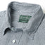 A close up of the hickory striped denim work shirts collar with white buttons and a green gitman vintage tag.