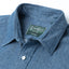 A closeup of the collar with white buttons and a green Gitman vintage tag.