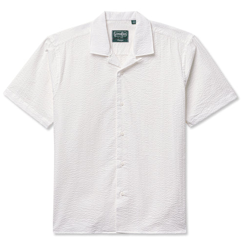 The White Seersucker Camp Shirt crafted from lightweight 3.5oz cotton seersucker. Featuring a breathable texture and relaxed camp silhouette, this warm-weather essential offers effortless summer style. Made in the USA.