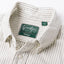 A close up photo of the grey striped button down collar, white buttons green Gitman Vintage tag.