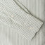 A green striped shirt sleeve and cuff, two white buttons.