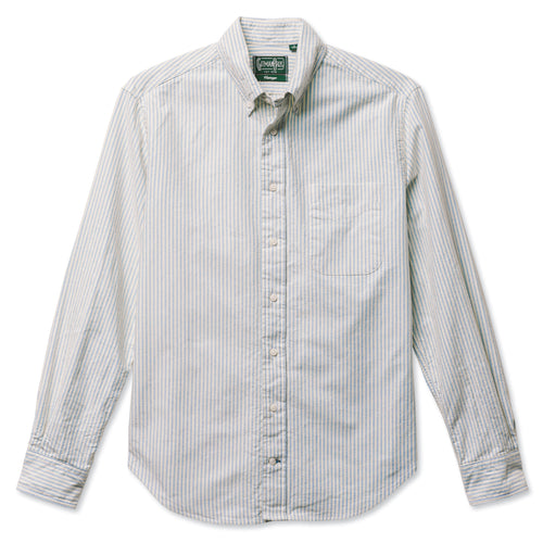 A blue striped button down shirt with a chest pocket, made from a brushed oxford fabric with white buttons.