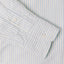 A blue striped shirt sleeve and cuff, two white buttons.