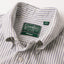 A close up photo of the navy striped button down collar, white buttons green Gitman Vintage tag.