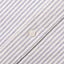 A navy striped brushed oxford fabric placket, with a white button.
