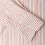 A red striped shirt sleeve and cuff, two white buttons.