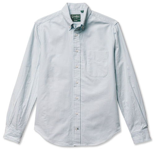 A blue button down shirt with a chest pocket, made from a brushed oxford fabric with white buttons.