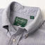 A close up photo of the navy button down collar, white buttons green Gitman Vintage tag.