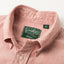 A close up photo of the red button down collar, white buttons green Gitman Vintage tag.