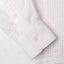 A white sleeve cuff with two white buttons.