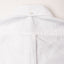 The back of the white button down tuxedo shirt, with a locker loop and a white button on the back of the collar.
