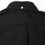 The back of the black overdyed oxford button down shirt with a locker loop and a white buttoned collar.