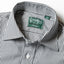 A close-up of the medium spread collar and the mother of pearl button on the lined placket.