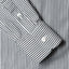 The cuff on the sleeve with two mother of pearl buttons. 