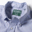 A close-up of the button down collar and a white button on the lined placket