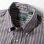 A close-up of the button down collar and a white button on the lined placket.