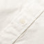A white button on the lined placket.