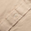 A white button on the lined placket.