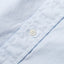A white button on the lined placket.