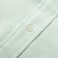 A white button on the stitched and lined placket.