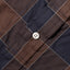 A white button on the stitched placket of the Brown Checked Organic Cotton shirt. 