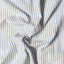 The texture of the fabric on the White Organic Cotton Dobby Stripe shirt.