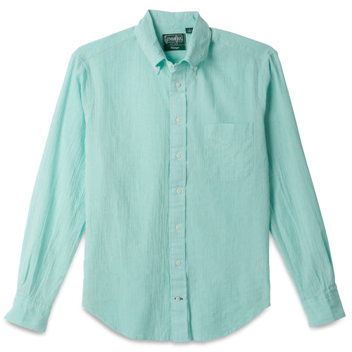 The Teal Chambray Dobby Stripe button down shirt, with a front pocket and white buttons on a stitched placket.