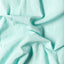 The texture of the fabric on the Teal Chambray Dobby Stripe shirt.