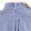 The back of the Blue Chambray Dobby Stripe shirt withe a locker loop and a a back button on the collar.