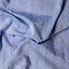 The texture of the fabric on the Blue Dobby Stripe Chambray Camp Shirt.