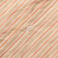 The white button on the front of placket.