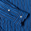 The barrel cuffs on the sleeve of the Indigo Awning Stripe shirt with white buttons.