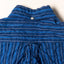 The back of the Indigo Awning Stripe shirt with a button on the back of the collar and the locker loop on the back.