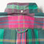 The back of the Plum Ikat Madras with a button on the back of the collar and the locker loop on the back.
