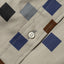 The white button on the stitched placket.