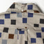 The back of the shirt with a locker loop and button on the back of the collar.