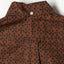 The back of the shirt with a locker loop and button on the back of the collar.