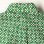 The back of the shirt with a locker loop and button on the back of the collar.