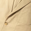 The lapel of the Khaki Twill Simple Jacket with a front pocket.