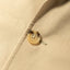 A close-up of the button on the Khaki Twill Simple Jackets fabric.