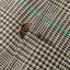 A close-up of the button and button hole on the Grey Glen Plaid Simple Jacket.