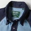 A close-up of the button up collar on the Nicholas Daley Chambray Western shirt with pearl snap buttons.