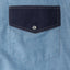 The pearl snap button on the flap pocket.