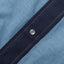 The pearl snap button on the stitched placket.