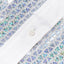 A close-up of the stitched placket and white buttons.