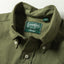 A close-up look at the button down collar with white chalk buttons.