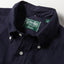 A close-up look at the button down collar with white chalk buttons.
