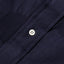 The white chalk button on the stitched placket.