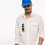 The American Poplin on the body of a a model styled with sunglasses in the left flap pocket and a blue hat.